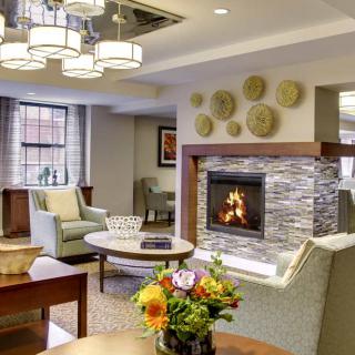A modern living room with a cozy fireplace, contemporary furniture, and stylish decor.