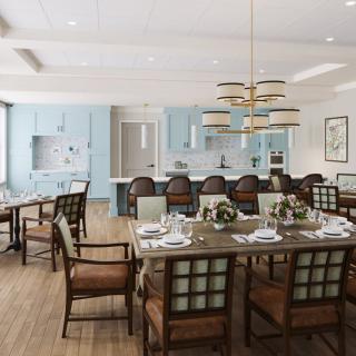 A spacious open-concept kitchen and dining area featuring modern interior design with stylish furniture and elegant light fixtures.
