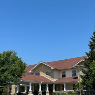 A charming residential building under a clear blue sky.