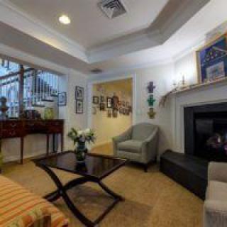 A cozy living room featuring a fireplace, comfortable seating, and elegant decor.