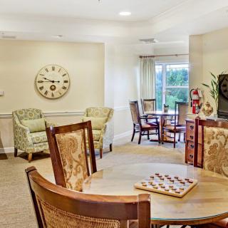 A well-lit dining and living area with wooden furniture and decor.