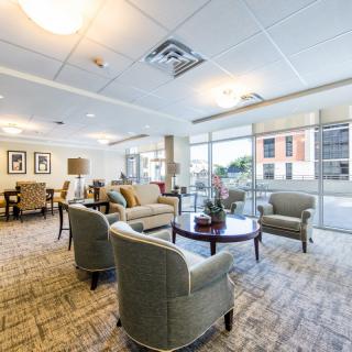 A modern lounge area with comfortable seating and large windows.