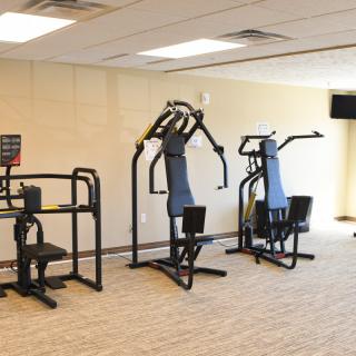 A gym with exercise machines for fitness and workouts.
