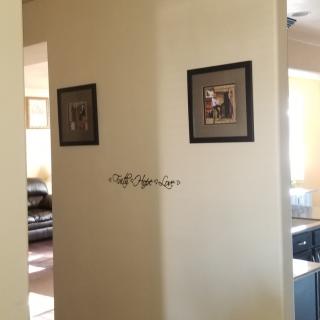 A home interior featuring a wall adorned with framed paintings.