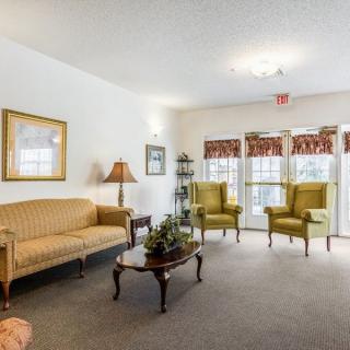 A cozy living room with vintage-style furniture and decor.