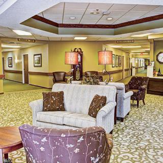 A comfortable lobby with sofas, armchairs, and warm lighting.