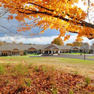 A scenic view of a building surrounded by vibrant autumn foliage.
