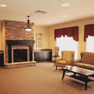 Cozy living room with a brick fireplace and comfortable seating.