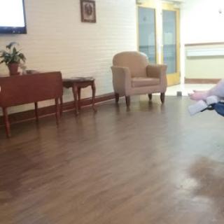 A quiet waiting area featuring a chair and a small table.