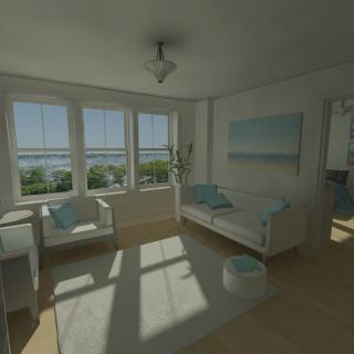 A bright, modern living room with large windows offering a stunning coastal view, featuring white and blue decor.