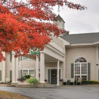 A building entrance surrounded by autumn foliage.