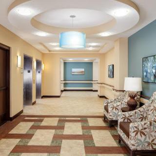 A well-designed lobby featuring elevators, comfortable seating, and modern decor.