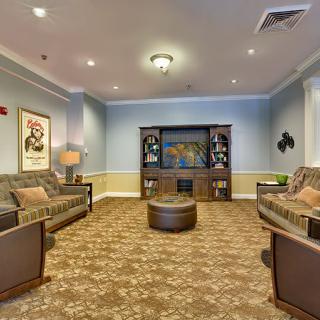 A cozy living room with two sofas, an entertainment center, and decor.