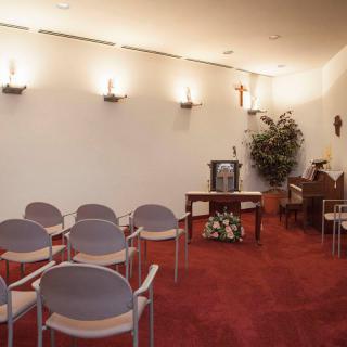 A small chapel interior with seating and an altar.