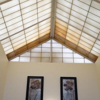 A beautifully designed interior featuring a skylight and decorative wall art.
