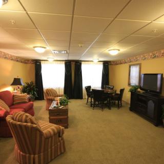 A cozy living room with comfortable seating and a television.