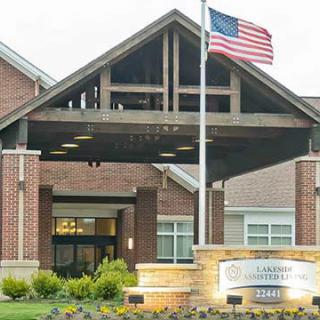Main entrance of a building with an American flag flying above.