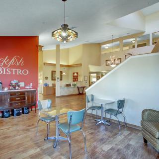 A cozy bistro interior with modern furniture and warm lighting.