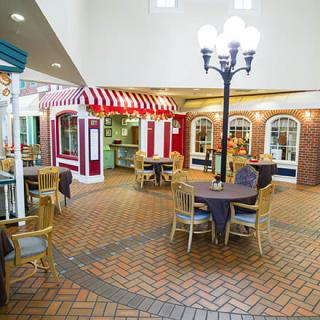 A charming indoor cafe setting with a striped awning and street lamp.