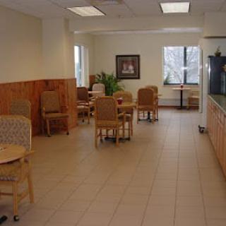 A quiet and neatly arranged waiting room with chairs and tables.