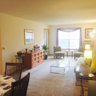 A cozy living room with elegant furnishings and ample natural light.