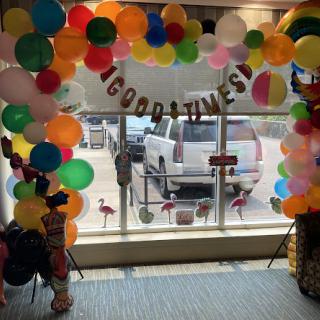 A festive entrance adorned with colorful balloons and a cheerful 'Good Times' banner, perfect for celebrating a special occasion.