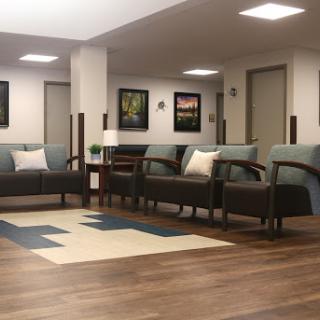 A modern and inviting seating area featuring stylish couches and decorative artwork.