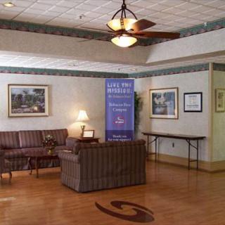 A cozy lobby area featuring comfortable seating, decorative art, and natural lighting.