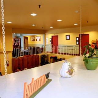 A cozy hotel lobby decorated with autumn-themed accents and indoor plants.