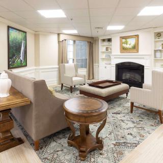 A cozy living room with elegant furnishings and a fireplace.