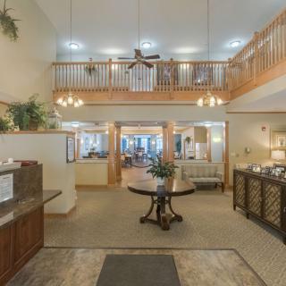 A spacious and elegantly designed lobby area with a high ceiling and luxurious furnishings.