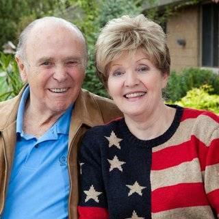 A joyful elderly couple enjoying a sunny day together.