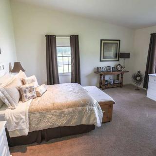 A cozy bedroom with a neatly made bed and tasteful decor.