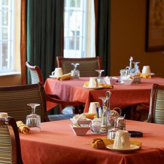A cozy restaurant dining room with tables set for a meal.