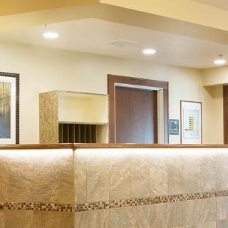 A modern reception area with a sleek front desk and tasteful artwork on the walls.