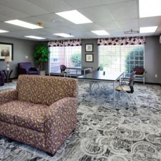 A spacious lobby area with comfortable seating and large windows providing natural light.