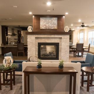 A modern living room with a central fireplace and stylish decor.