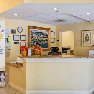 A welcoming reception area with a desk and colorful artwork on the walls.
