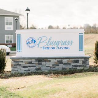 Sign for Bluegrass Senior Living outside a building.