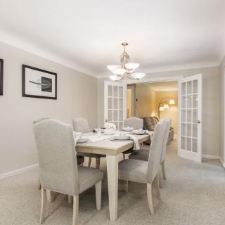 A modern dining room with a set table and elegant decor.