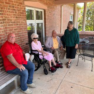 A delightful gathering of family and friends enjoying a sunny day outside.