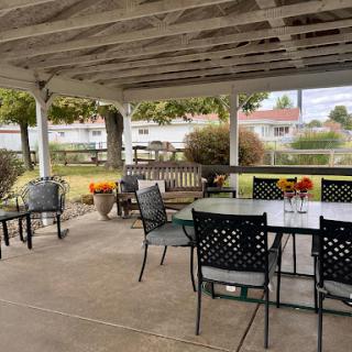 A cozy outdoor patio setting with comfortable seating, perfect for gatherings and enjoying nature.