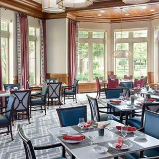 A beautifully decorated restaurant dining room with neatly arranged tables and elegant furnishings.