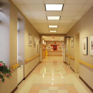 An empty hospital corridor with clean and well-lit surroundings.