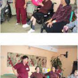 Caregivers interacting with elderly residents in a nursing home setting.