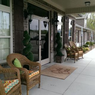 A cozy entrance with wicker seating and decorative plants, inviting relaxation.