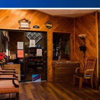 Cozy waiting room with wooden paneling and comfortable seating.