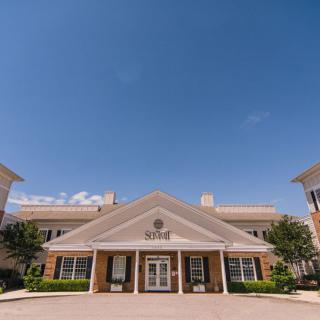 A symmetrical facade of a building under a clear blue sky.