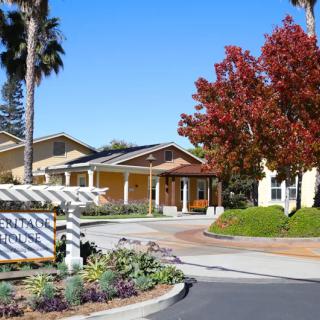 A scenic view of a building surrounded by colorful trees and clear blue sky.