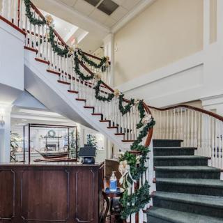 A decorated staircase with garlands in a reception area.